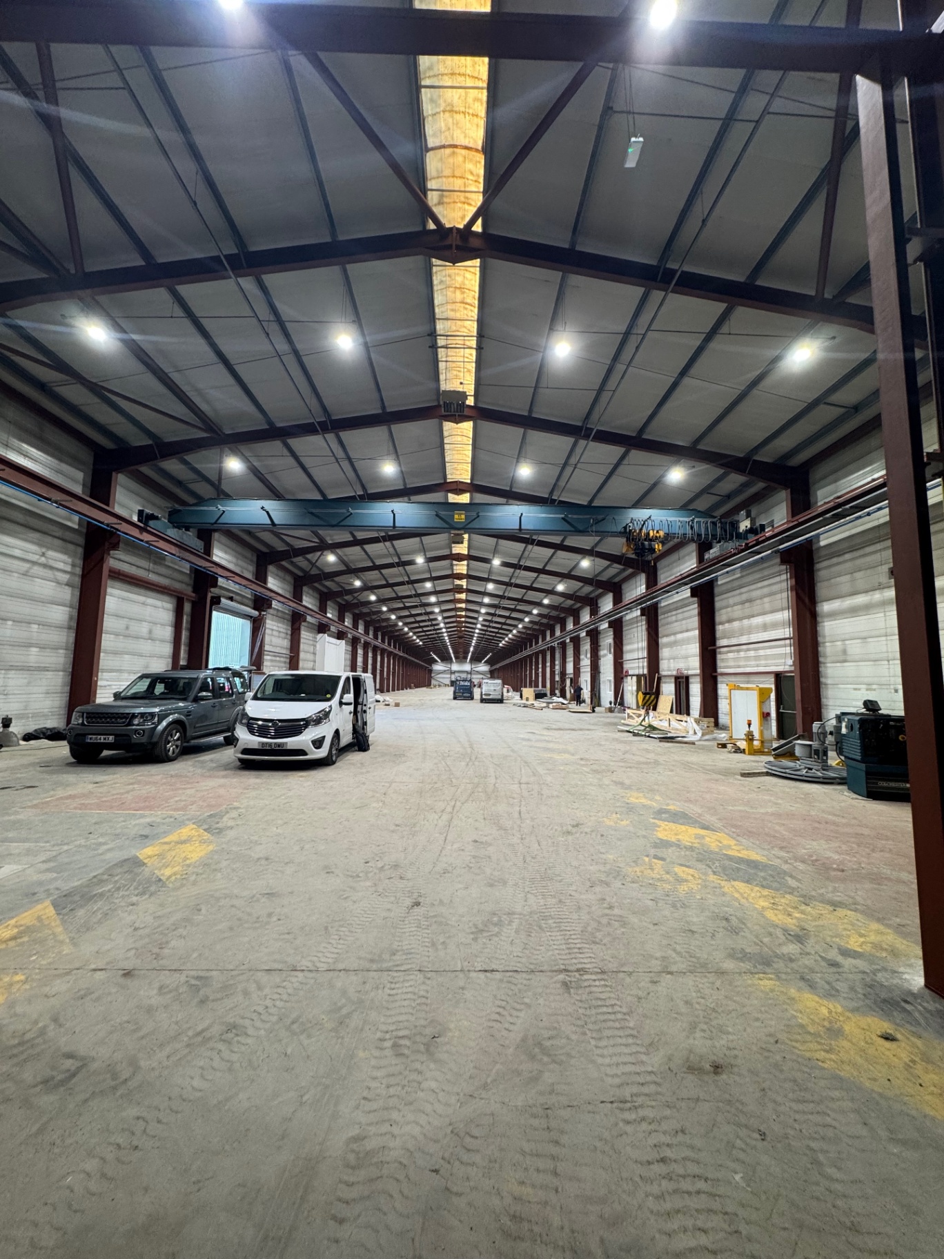 Wide industrial warehouse view with new LED high-bay lighting