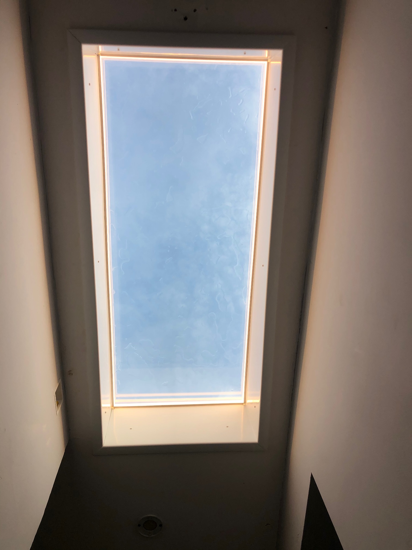Skylight reveal trimmed with warm LED edge lighting