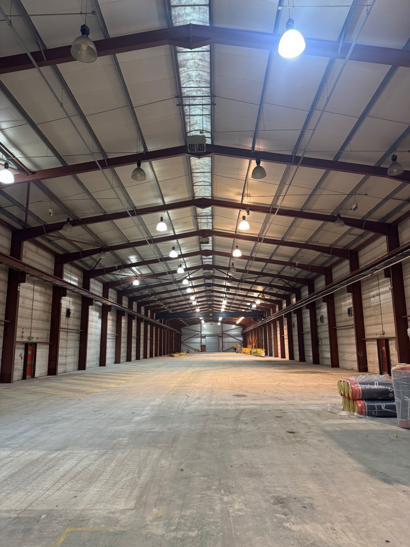 Warehouse interior with overhead lighting and steel structure